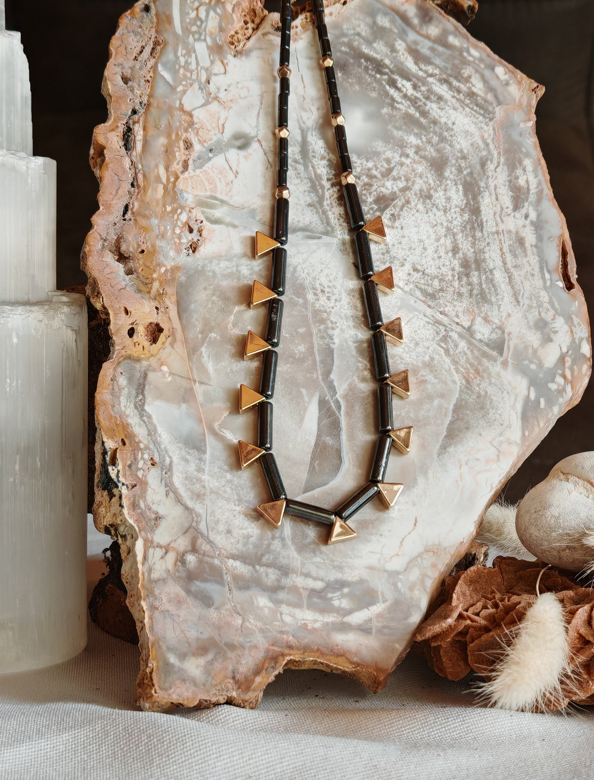 Collier egypte hemtatite sur un support en roche blanche